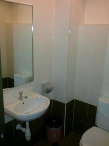 a bathroom with a sink and a toilet at Hotel Remix in Cameron Highlands