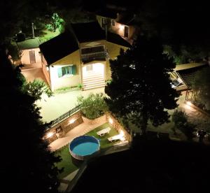 an overhead view of a house with a swimming pool at night at Anna's Country Villa Privé in Karés