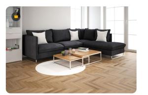 ein Wohnzimmer mit einer schwarzen Couch und einem Couchtisch in der Unterkunft Test Property Name 