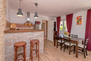a kitchen and dining room with a table and chairs at Apartments Priko in Stari Grad