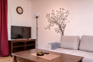 a living room with a couch and a table at Apartments Priko in Stari Grad