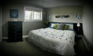 a bedroom with a bed and a window at Cowichan Calling in Lake Cowichan