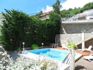 a swimming pool in front of a building at Apartments Belvedere Lovran in Lovran