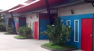 a row of brightly colored doors on a building at UII Boutique Place in Sakon Nakhon