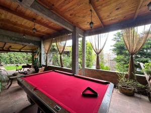 a pool table in the middle of a room at El Encanto Residence in Morelia