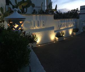 a group of lights on the side of a white wall at Club Azzurro Hotel & Resort in Porto Cesareo