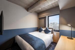 Letto o letti in una camera di いやし処ほてる寛楽 久留米駅前