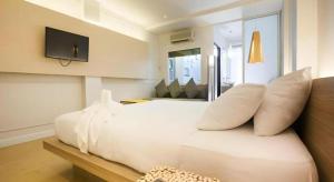 a white bed with white pillows in a room at The Bed Hotel Hatyai in Hat Yai
