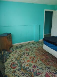 a bedroom with a bed and a table and a rug at GpL 5544 Cozy Getaway with Bright Colors & Full Kitchen in Fort Myers +4 photos