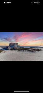 a picture of a beach with a sunset at Coastal Shores Condo in Biloxi