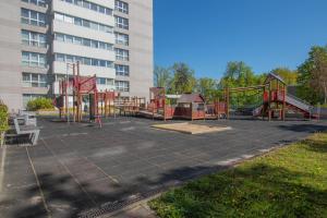 an empty playground in front of a building at Comfort & Views over Riga Apartment near Airport and City Center in Rīga