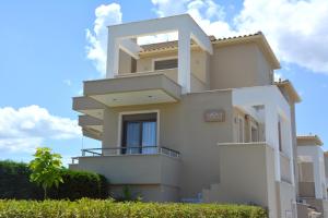 a building with balconies on the side of it at Niovi Boutique Apartments in Afitos