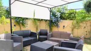 a patio with chairs and tables under a canopy at I Registi in Scalea