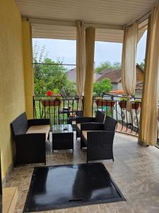 a living room with couches and a balcony at Pensiunea Veronica in Baile Felix +15 photos