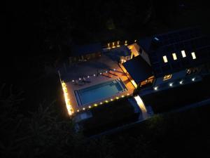 an overhead view of a house with a swimming pool at night at Villa Tin & Koča Tin - Nature, Water and Peace in Prestranek