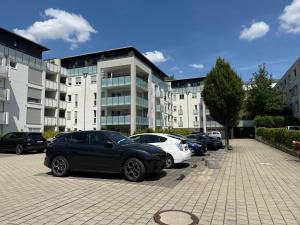 a parking lot with cars parked in front of a building at Ferienwohungen Akwant in Baden-Baden