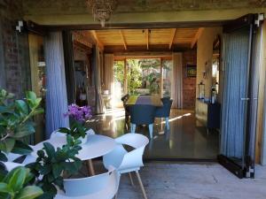 a living room with a table and chairs at Winelands Manor Vineyard Views in Riebeek-Kasteel