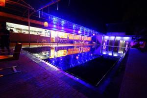 a swimming pool with purple lights in a building at ReeCha Hotel Mullai - Near Jaffna in Kilinochchi +17 photos