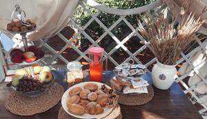 a table topped with bowls of fruit and other foods at B&B Corallo in Capilungo