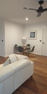 a living room with a white couch and a table at R n R Yamba in Yamba