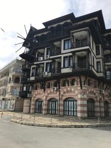 a building with a windmill on the side of it at Windmill Nessebar studio with sea view in Nesebar +22 photos