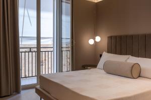 a bedroom with a bed with a view of the ocean at Alcova Camere in Centro in Agrigento