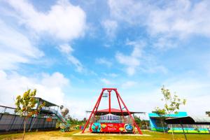 a playground with a red frame in a park at ReeCha Hotel Mullai - Near Jaffna in Kilinochchi