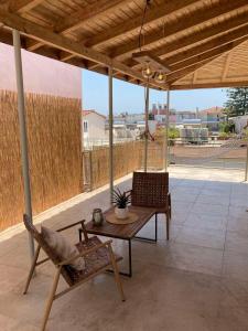 a patio with a table and chairs on a patio at Star lounge in Preveza
