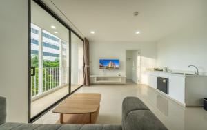 a living room with a couch and a table at SHIN Patara Living Hotel in Bangkok