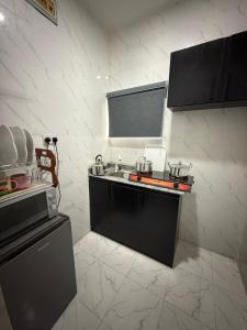 a kitchen with a sink and a counter top at Private Fully Serviced Studio Apartment At Ogudu , AC, Private kitchen and bathroom, Not A Shared, 5 percent off Weekly and 10 percent off Monthly Stays in Lagos