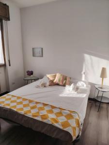 a large bed in a room with two tables at Villa Bella Porto Valtravaglia in Porto Valtravaglia