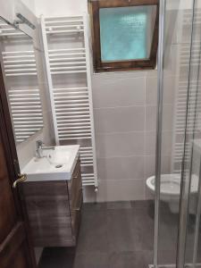 a bathroom with a sink and a toilet and a window at Villa Bella Porto Valtravaglia in Porto Valtravaglia