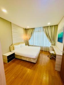 Vortex suites klcc by Yashrib في كوالالمبور: غرفة نوم بسرير أبيض ونافذة