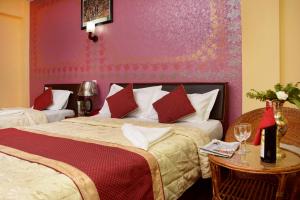 
a bed room with two beds and two lamps at Kathmandu Eco Hotel in Kathmandu
