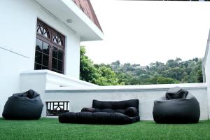 two bean bags sitting on a lawn in front of a house at Tribe Hostel in Kandy +1 photo