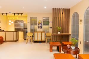 a waiting room with orange chairs and a table at Central Boutique Villa , in old Town in Hoi An