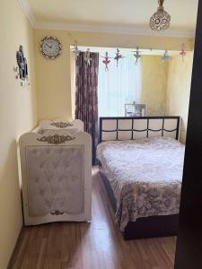 a bedroom with a large bed and a window at SweetHome in Sevan