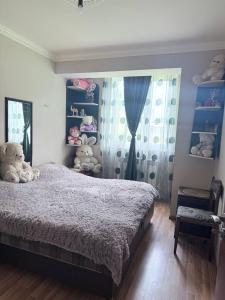 a bedroom with a bed with teddy bears on it at SweetHome in Sevan