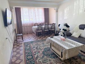 a living room with a panda bear sitting on a couch at SweetHome in Sevan