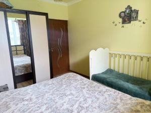 a bedroom with a bed and an open door at SweetHome in Sevan +1 photo