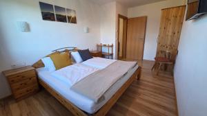 a bedroom with a bed and a wooden floor at Haus Tauernseitn in Schladming