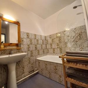 a bathroom with a bath tub and a sink at Le Tyrol in Les Deux Alpes +75 photos