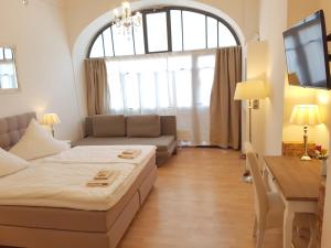a living room with a bed and a large window at GASTEIN by ROCKCHAIR Apartments l SUPERHOST Status l 2 Bedrooms Boxspringbeds 1,5 Bathrooms - Cozy Family & Business Flair welcomes you! in Berlin