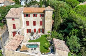 an aerial view of a large stone house with red shutters at Le Clos Marthe - Suite de charme in Corneilhan