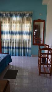 a living room with a bed and a mirror at Villa Paragon in Negombo