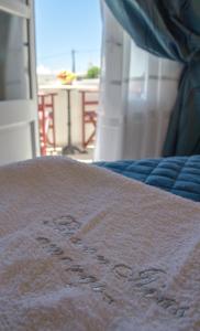 a bed with a blanket with the word bed written on it at Pension Ilias - Chora Amorgos in Amorgos