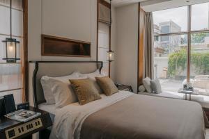 Postel nebo postele na pokoji v ubytování Honor Hotels & Resorts · Yun Shu Dali + 114 fotografií