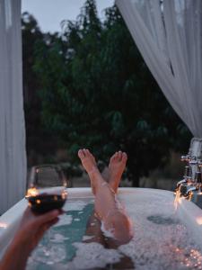 a person in a bath tub with their feet in the water at Naivasha Cottage in Deloraine