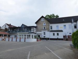 a parking lot in front of a building at Hotel Diele in Detmold