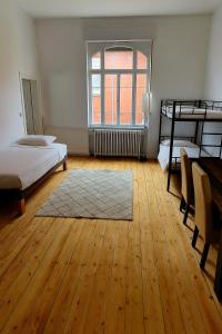 a room with two beds and a wooden floor at Ruhig in zentraler Lage mit Villen-Flair in Bad Kreuznach